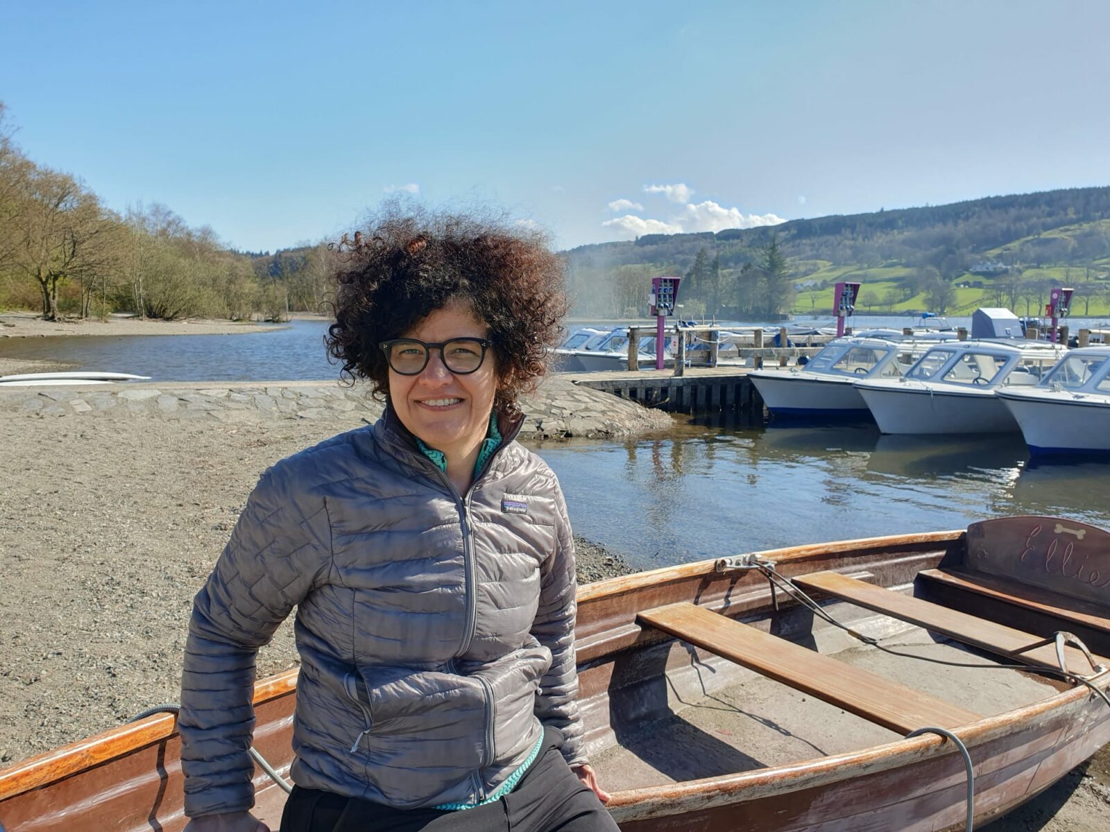 Die Klimaforscherin Sasha Kosanic lehnt an einem Ruderboot an der Küste vom Lake District